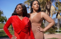 two women posing for a photo in a park